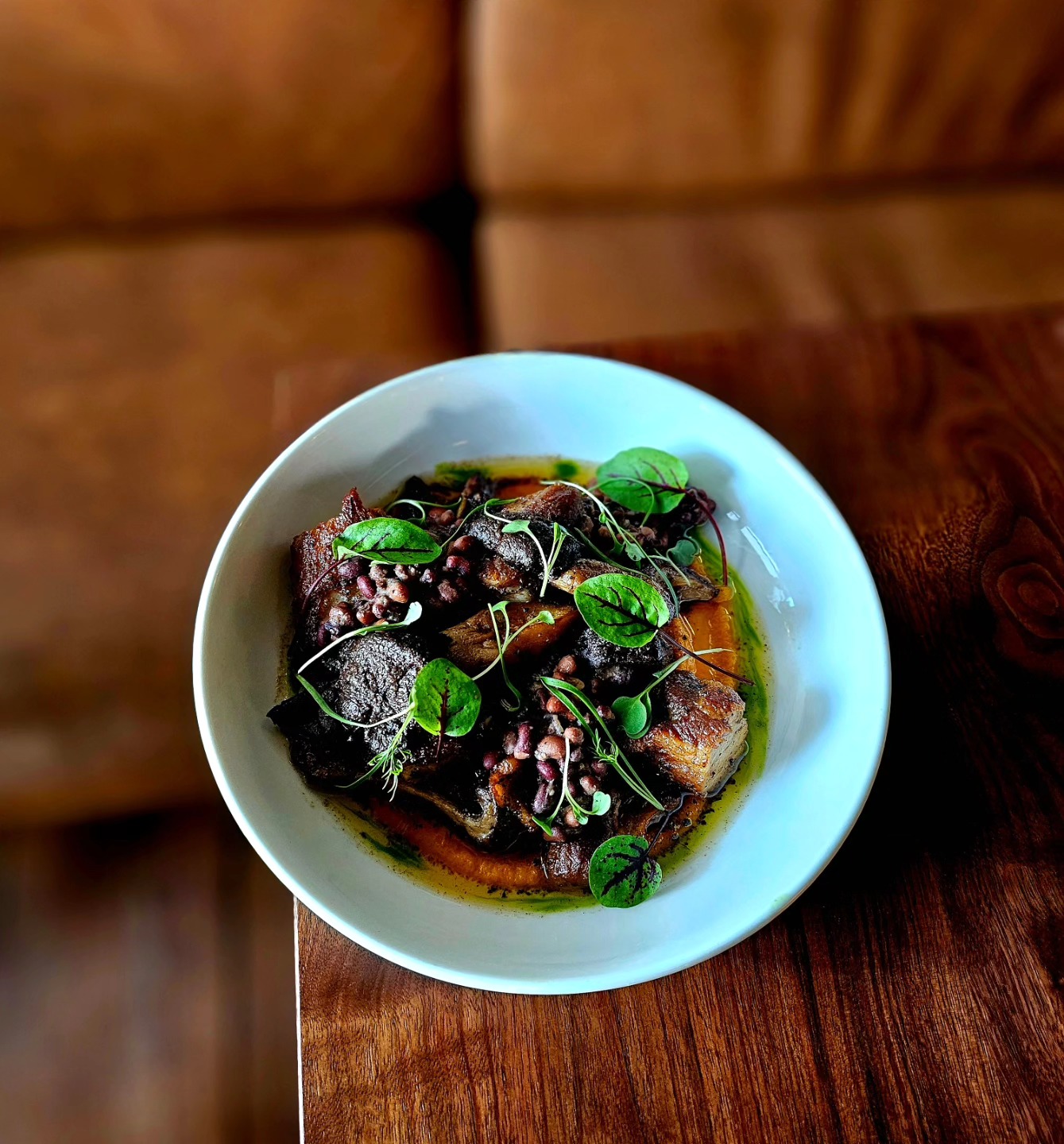 A dish in a white bowl on a wooden table