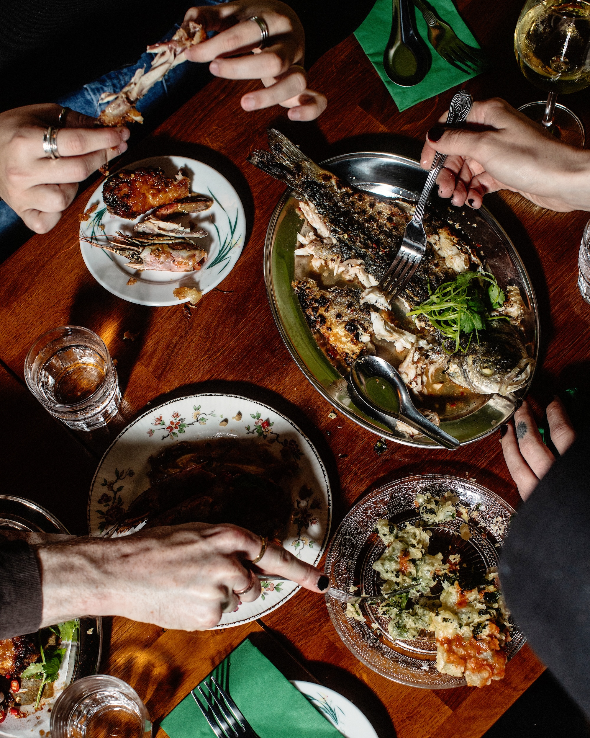 Diners dig into whole fish, chicken, and other dishes.